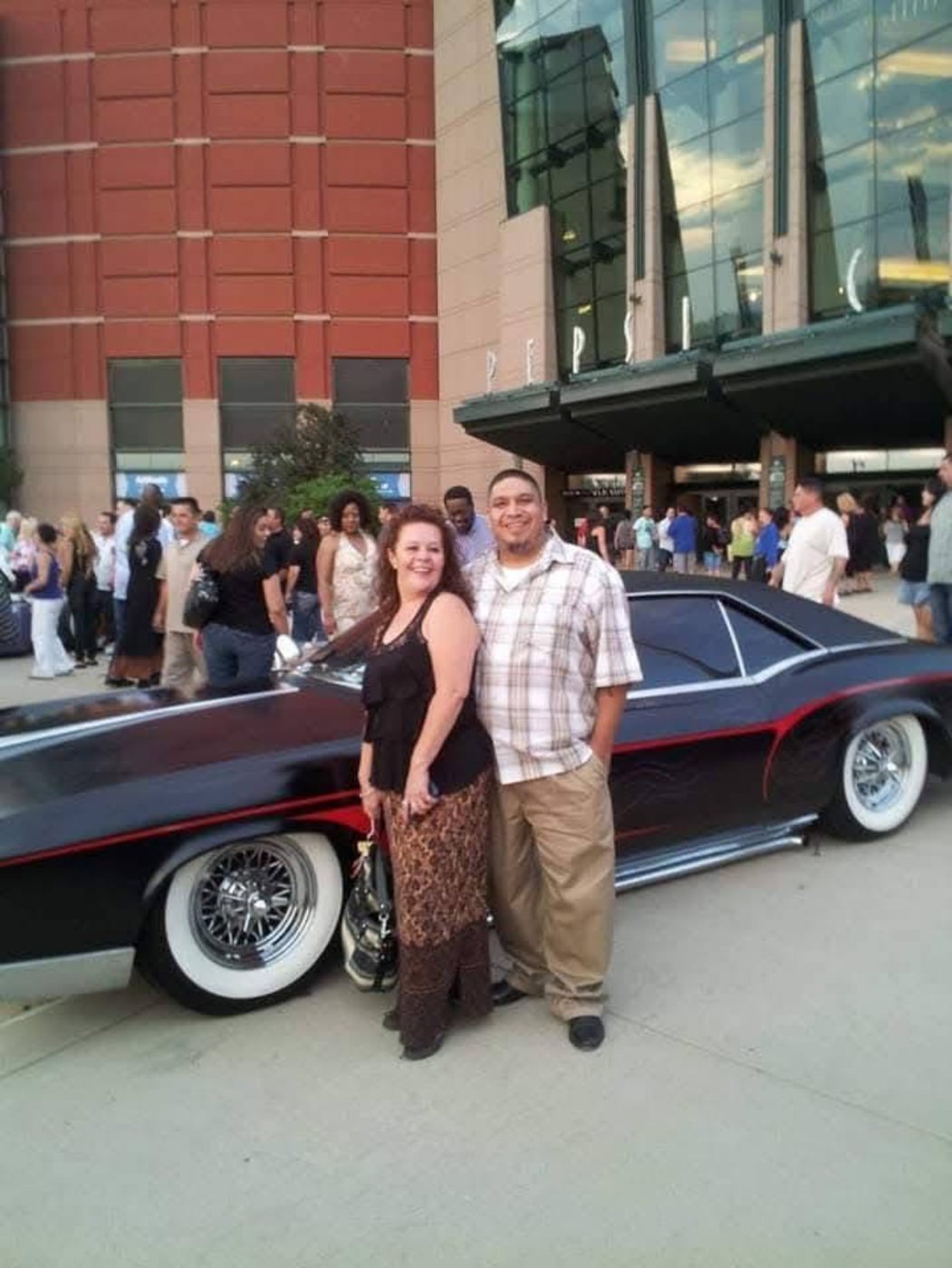Dressed up with Debbie by the lowrider